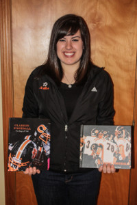 (Photo by Cindy Nellis) Bri displays her two national award winning books: 2012’s “Clarion Football: The Boys of Fall” and 2011’s “Clarion Football: One Team One Goal”