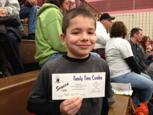 Photo by Brian Burford Ethan with the gift certificate he won at halftime