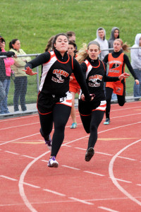 (Photo by G. Chad Thomas) Kyla Miles taking handoff from Madison Weaver in 4x100