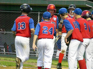 (Photo by Christie Datko) Skylar Rhoades getting congrats from the team as he comes after blasting a homerun!