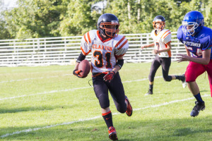 Archer Mills runs the ball down field for the Bobcats