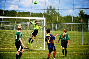 CRVS 3 Donnie Cunningham skies to prevent the Millcreek goal