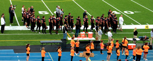 (Photo by G. Chad Thomas) Officials, Team, Cheerleaders and Elementary Cheerleaders honor our country during the National Anthem. 