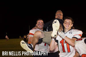 (Photo by Bri Nellis - Bri Nellis Photography) Coach Wiser being carried off field by players after win number 184