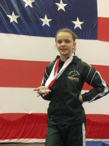 (Photo by Patty Lewis) Laken displays hardware she won at Stars and Stripes Co-ed Invitational