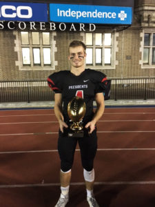 (Photo provided by Bill Hearst) Cody with the 2016 Presidents Bowl Trophy